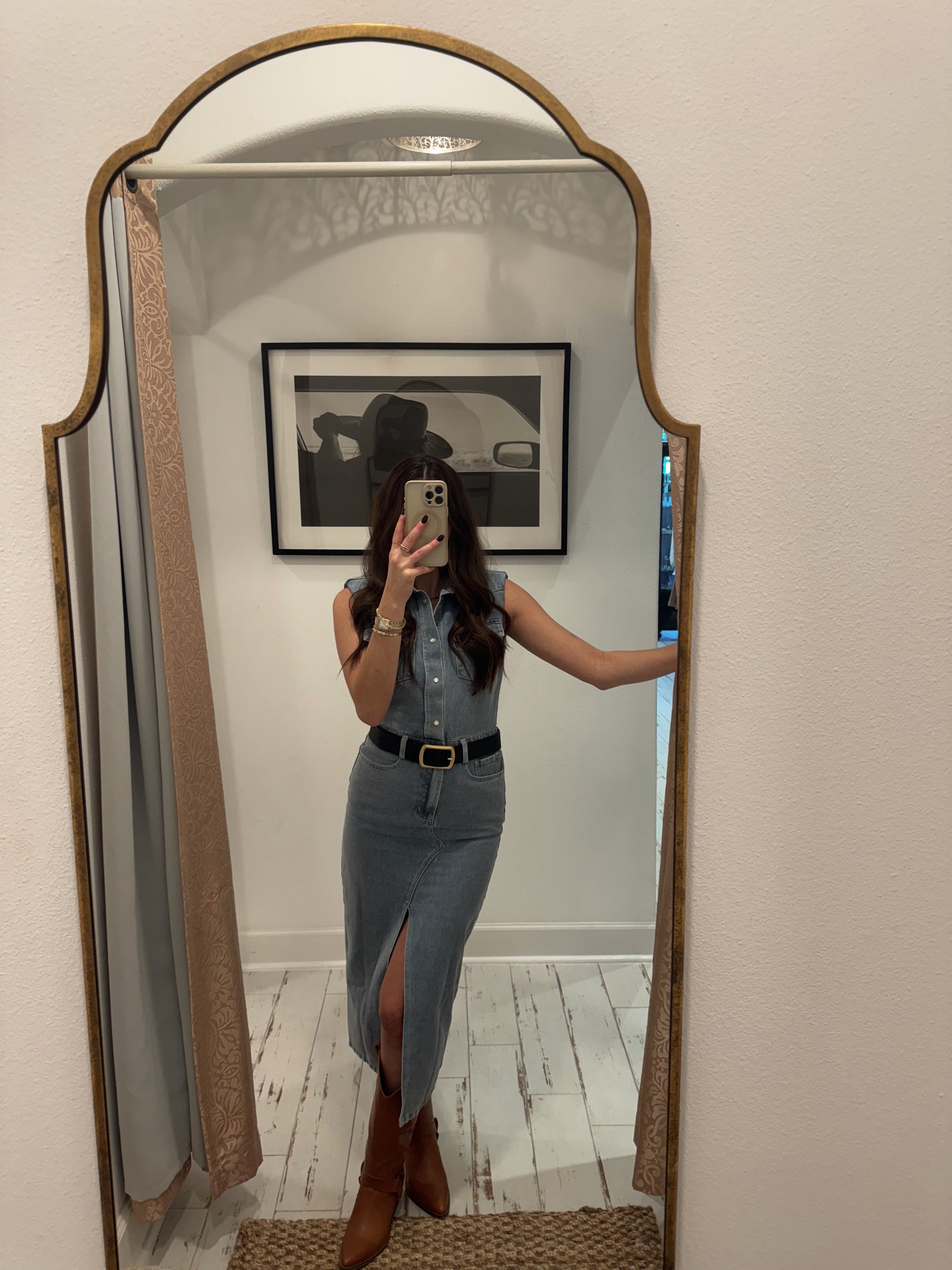 Full-length mirror photo of a woman wearing a denim maxi dress.
